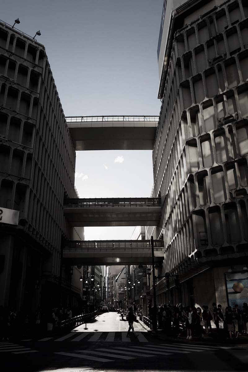 building people walking under pass road