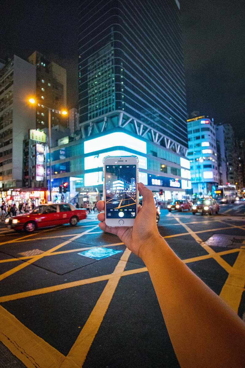 building person taking picture using silver iPhone 6 urban