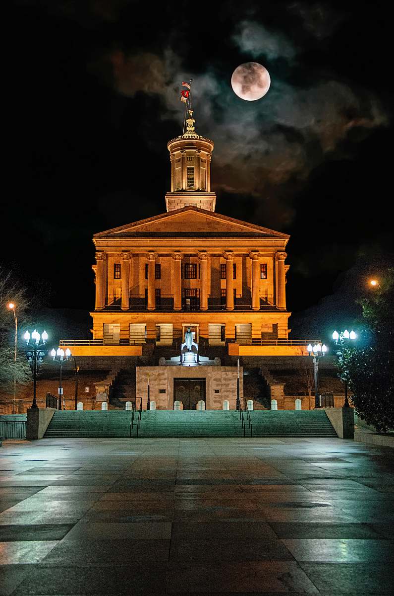 building photo of building and white fullmoon downtown