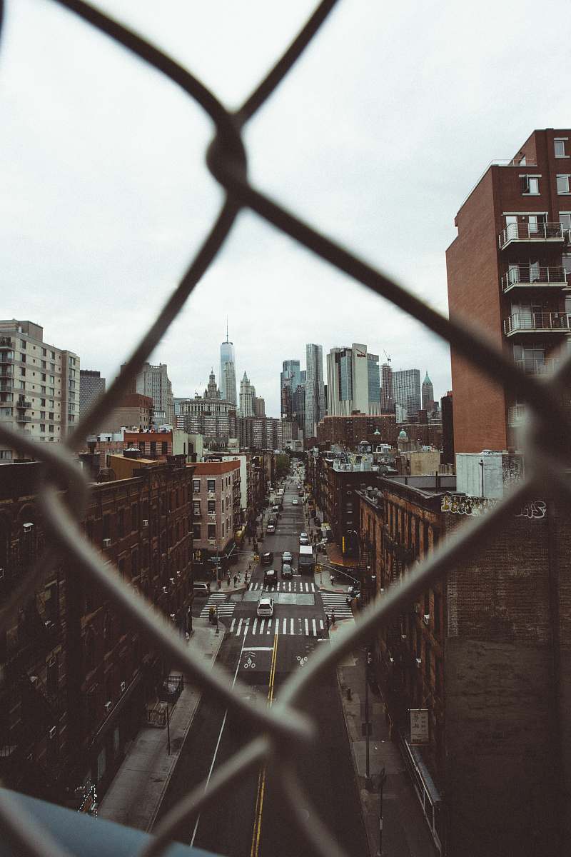 urban photo of city building with cyclone fence frame town