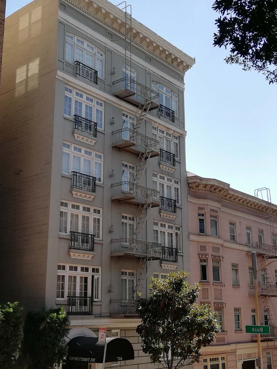 building pink and gray buildings under white sky high rise