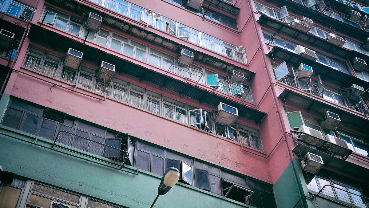 building pink and green painted building high rise