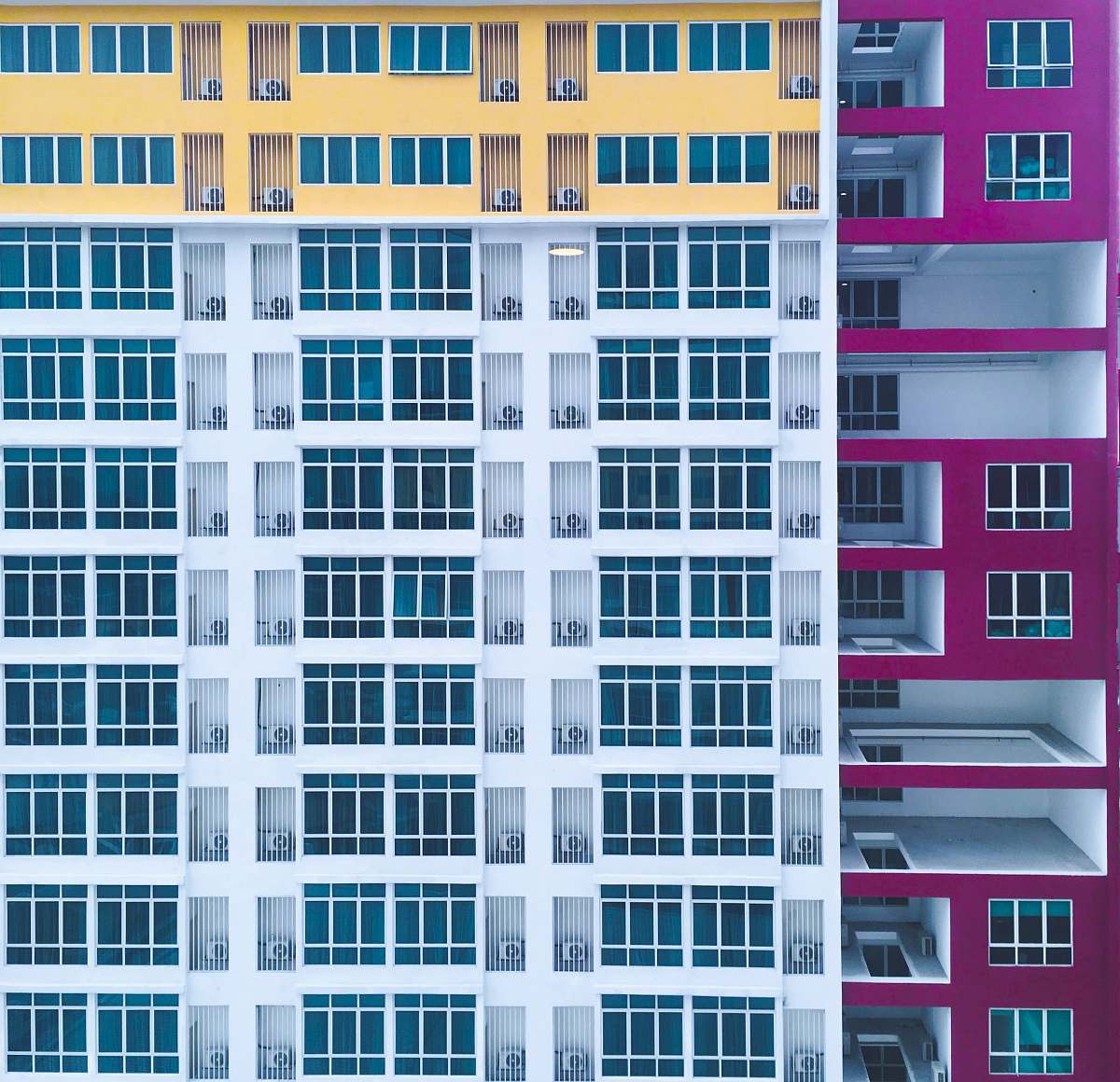 building purple-white-and-yellow concrete building urban