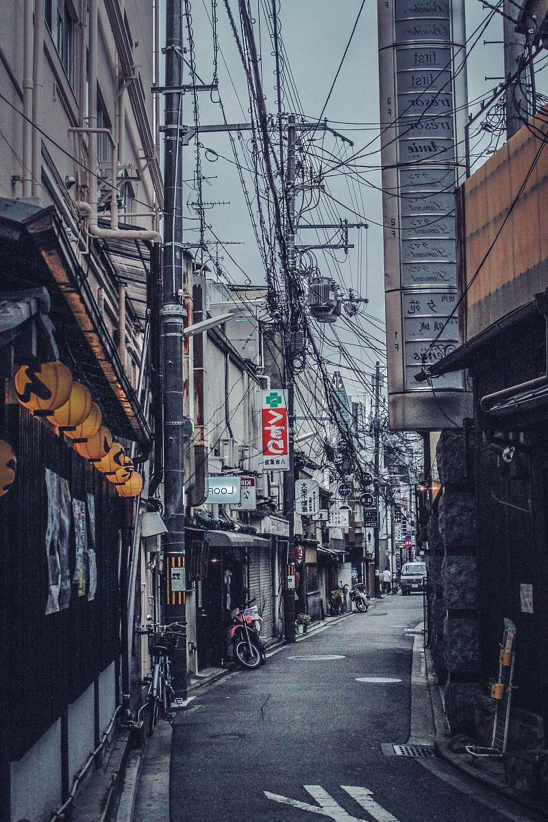 japan red and black motorcycle near city building person
