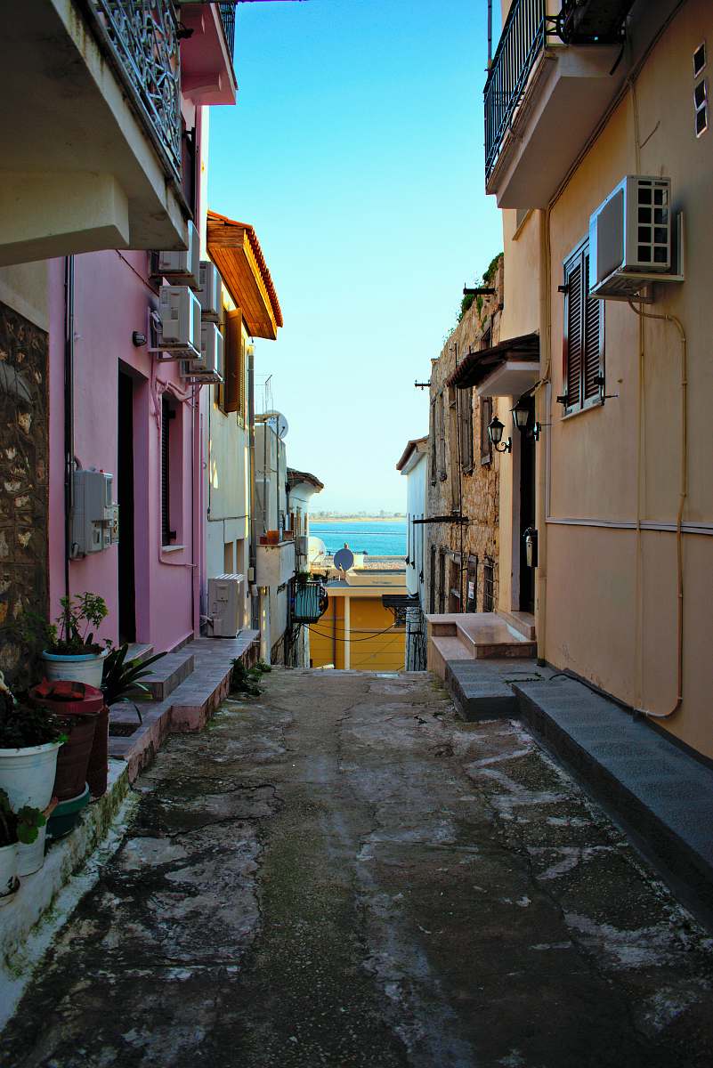 building road between buildings during day road