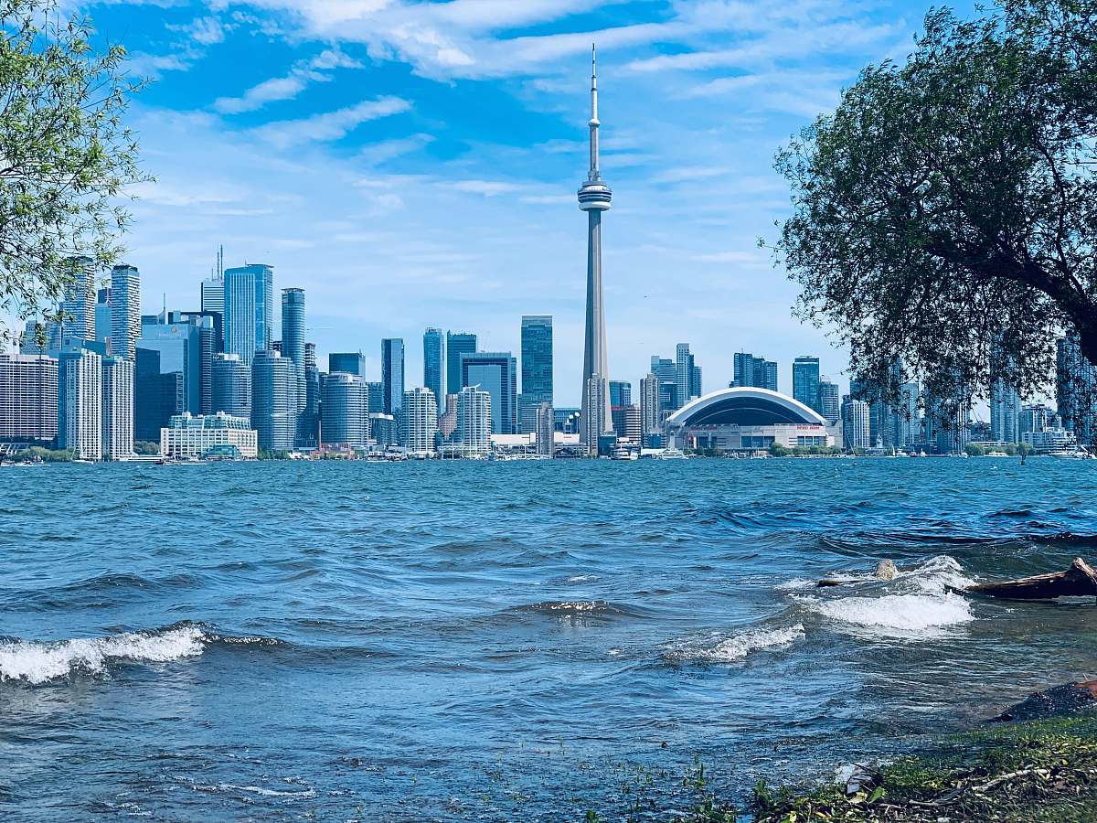 building sea beside buildings during daytime high rise