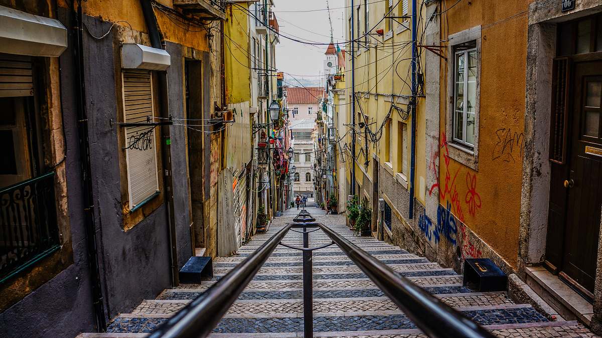 building stairs in between colorful buildings street