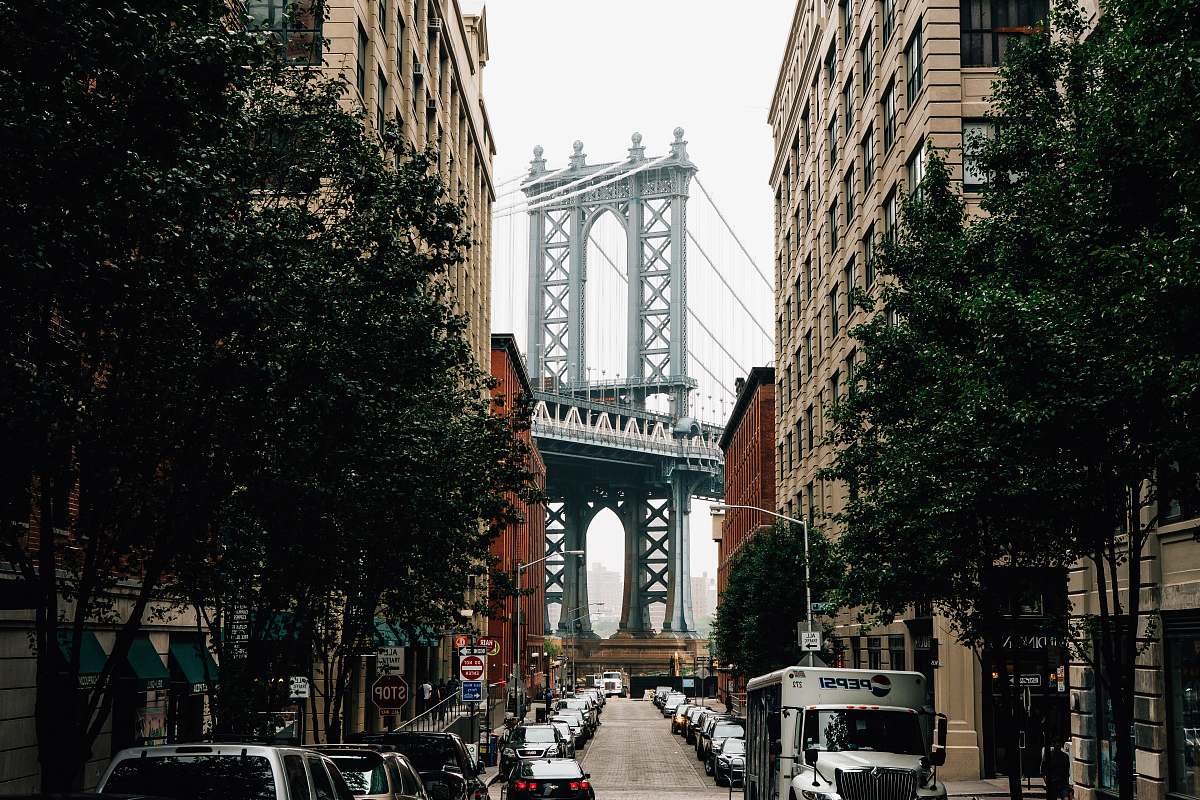 dumbo street with car lot in the middle of high-rise buildings building