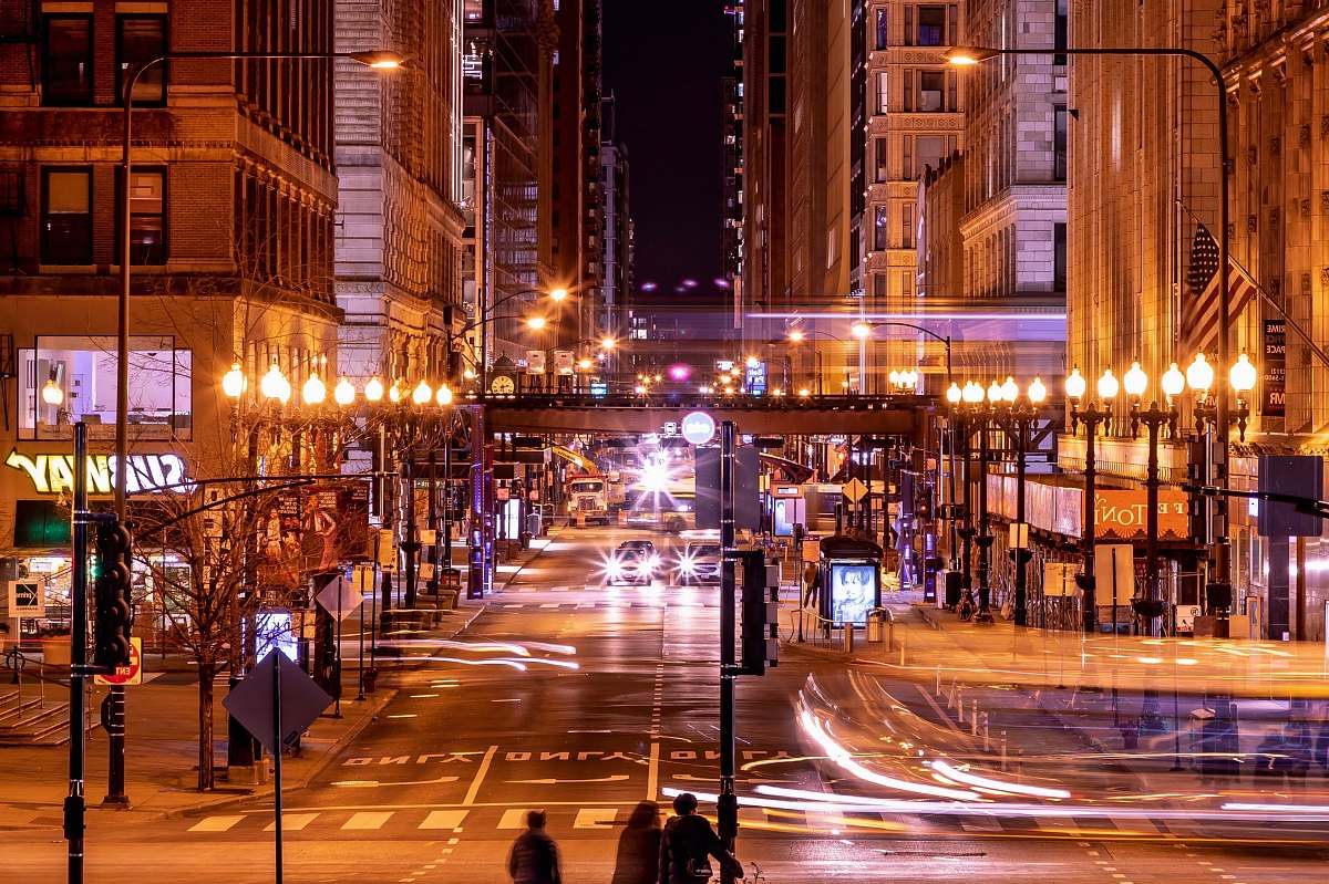 urban time-lapse photography of lighted buildings at night road