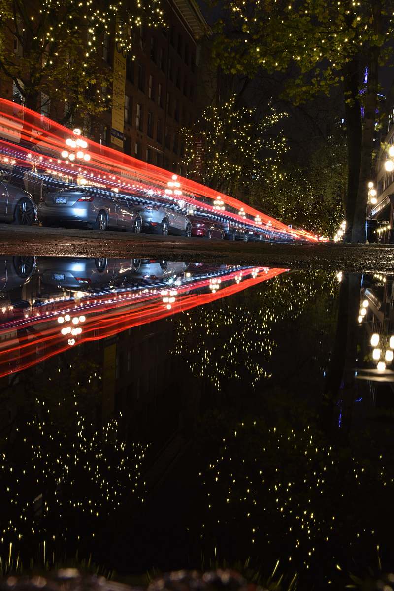 building timelapse photography of vehicles on road at night metropolis