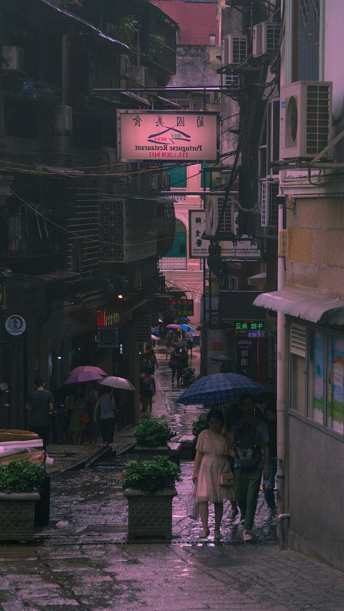 road two man and woman under blue umbrella during daytime street