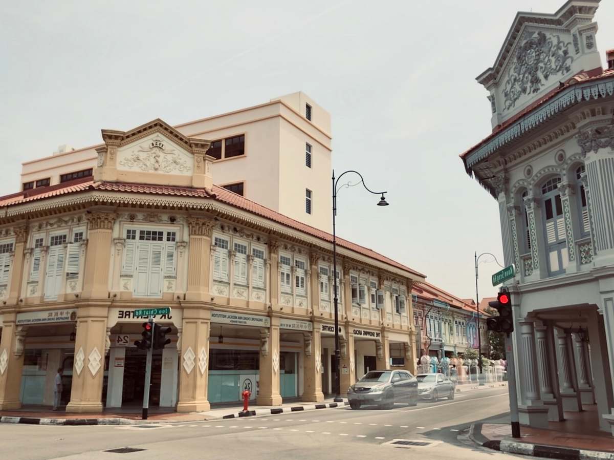 building two vehicles beside buildings road