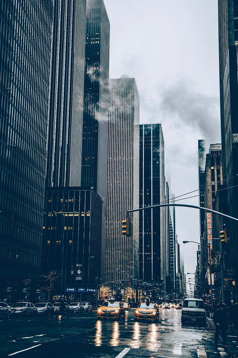 urban two yellow cars besides concrete buildings new york