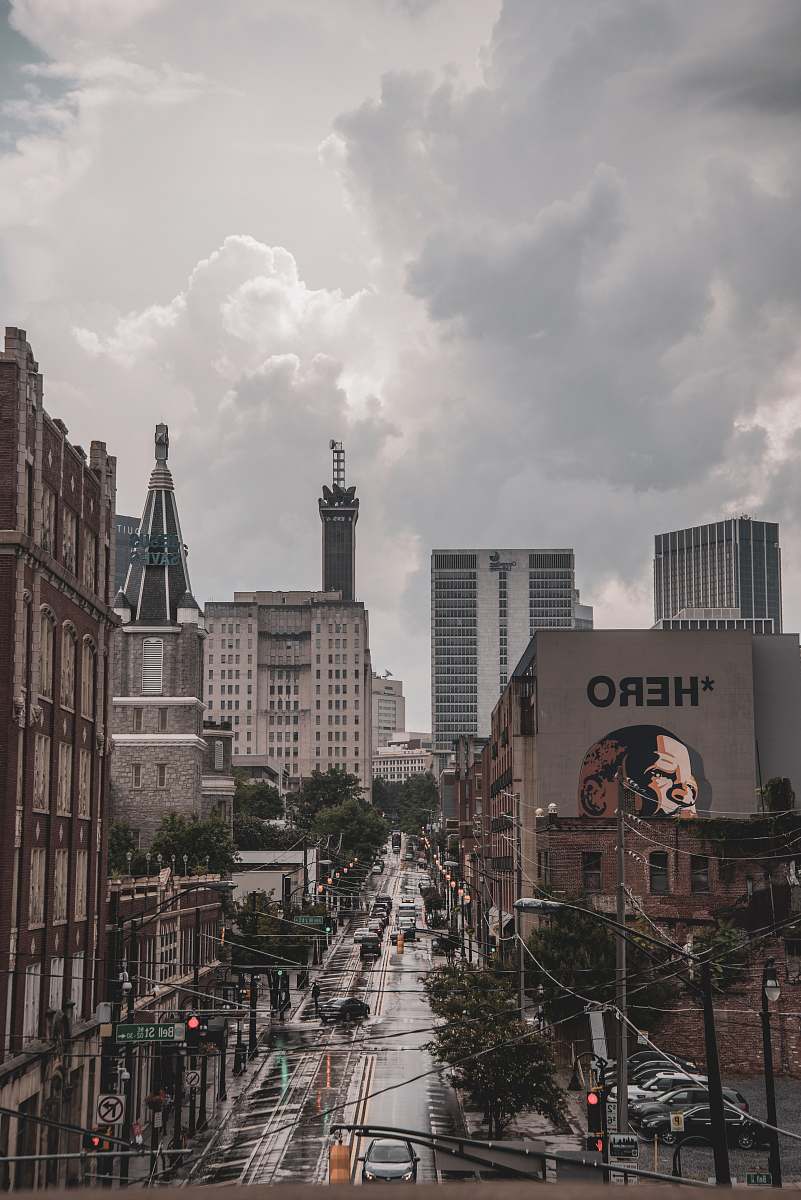 urban vehicles on road beside building during daytime grey