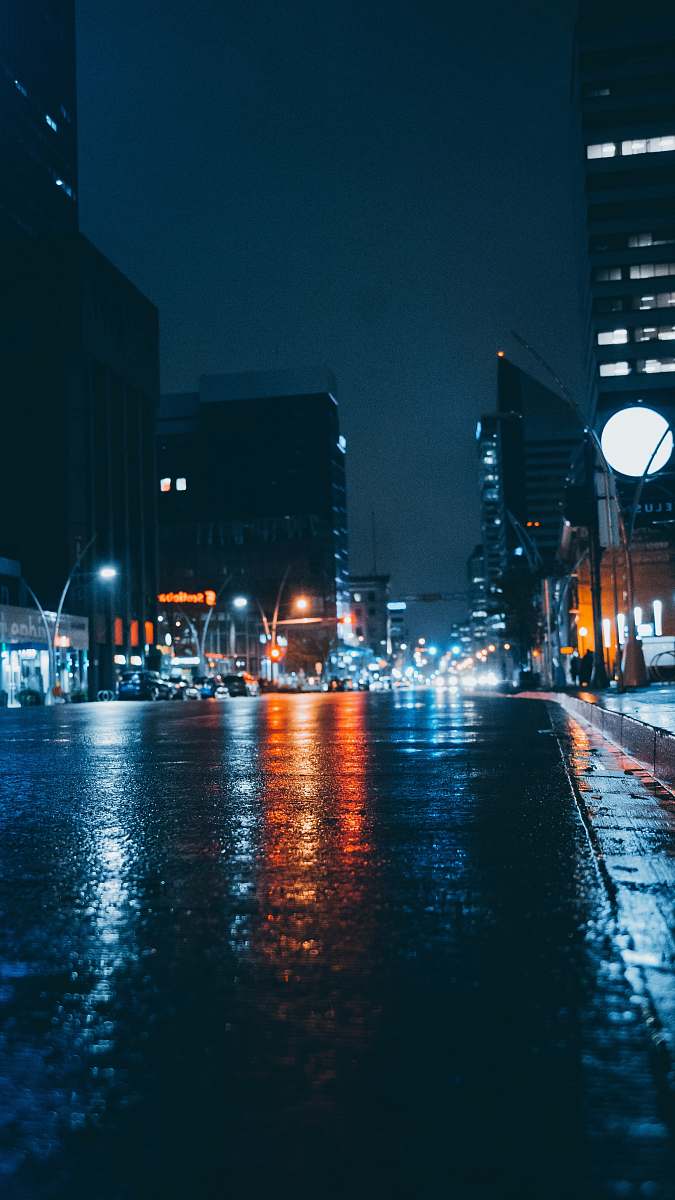 downtown wet gray road near high-rise buildings during night urban