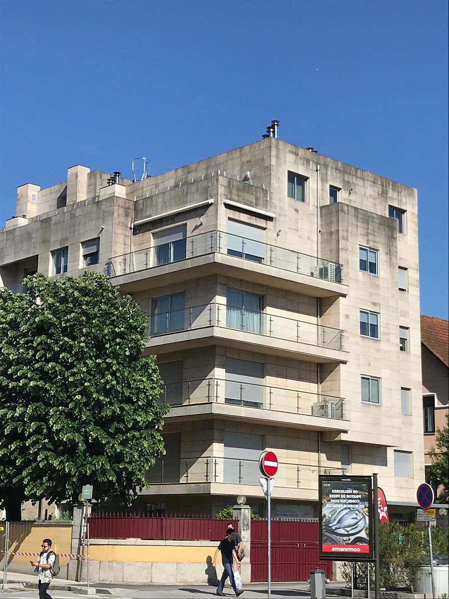 building white concrete 6-storey building human