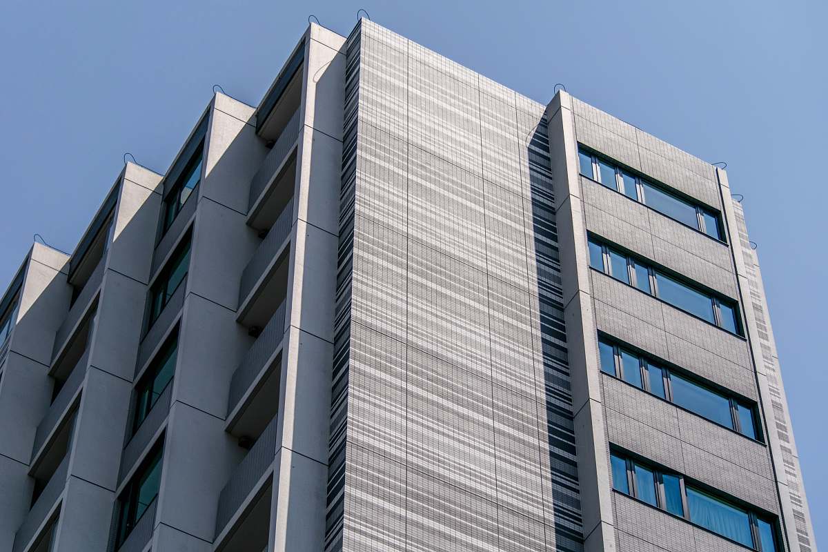 building white concrete high-rise building under blue sky home decor