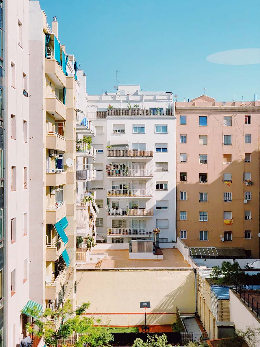 building white high rise buildings under blue sky high rise