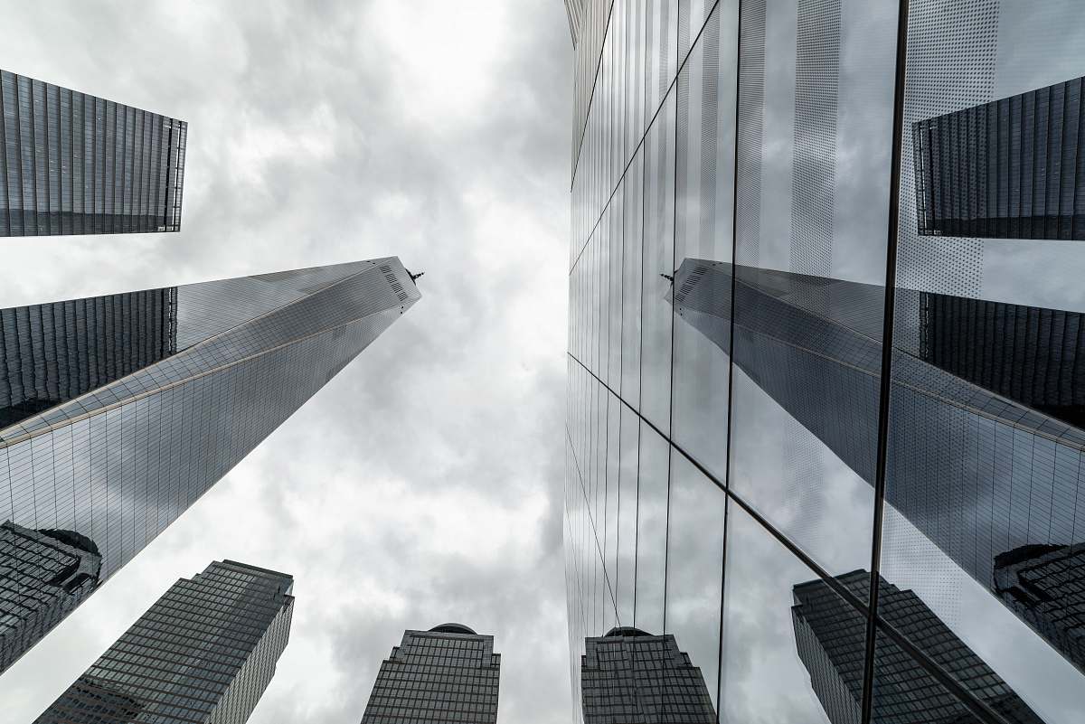 Experience the stunning perspective of towering office buildings captured from a unique worm's-eye view. This striking image showcases the grandeur and architectural beauty of skyscrapers, emphasizing their height and intricate designs. Perfect for urban-themed projects, marketing materials, or as a backdrop for discussions on modern architecture and city life.