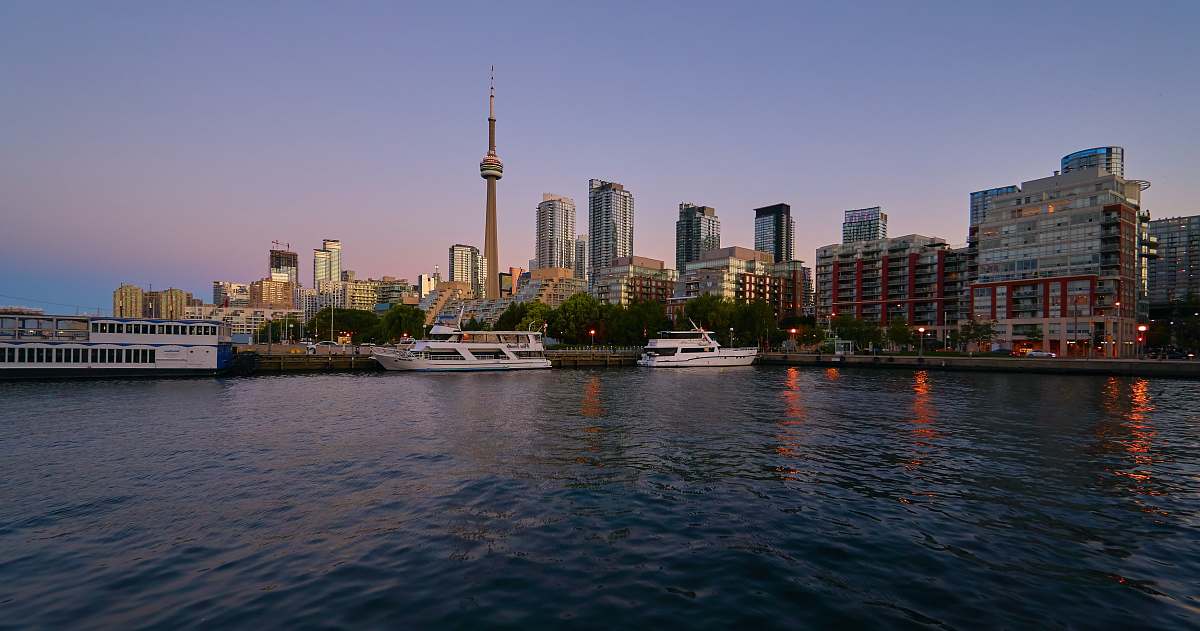 building yacht docked near high rise buildings urban