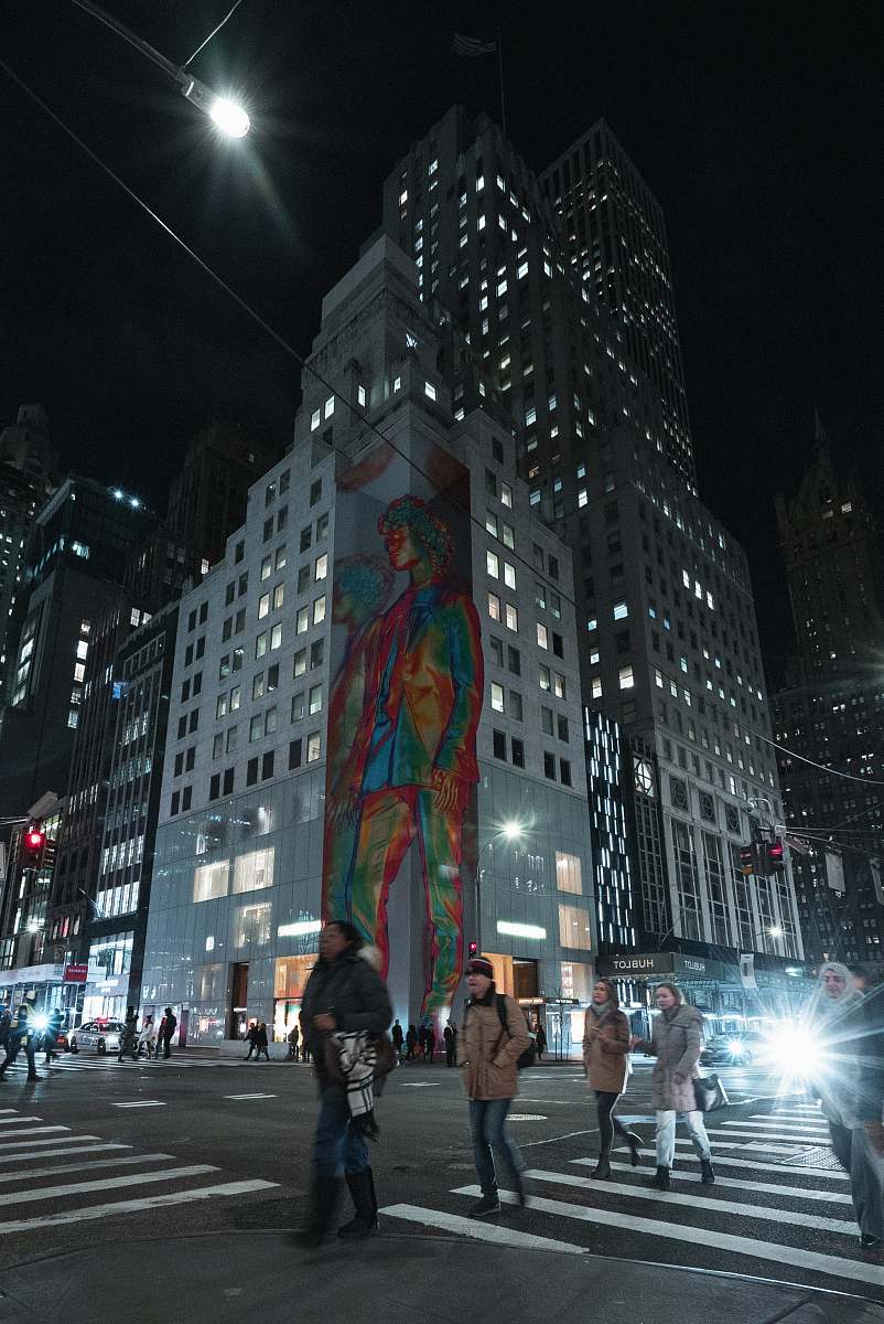 pedestrian people walking on pedestrian lane with high-rise building background at night-time person