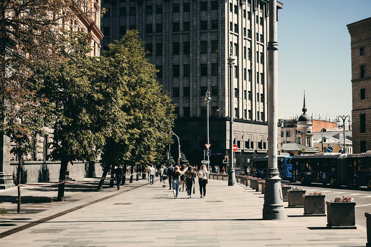 pedestrian people walking on sidewalk at daytime person