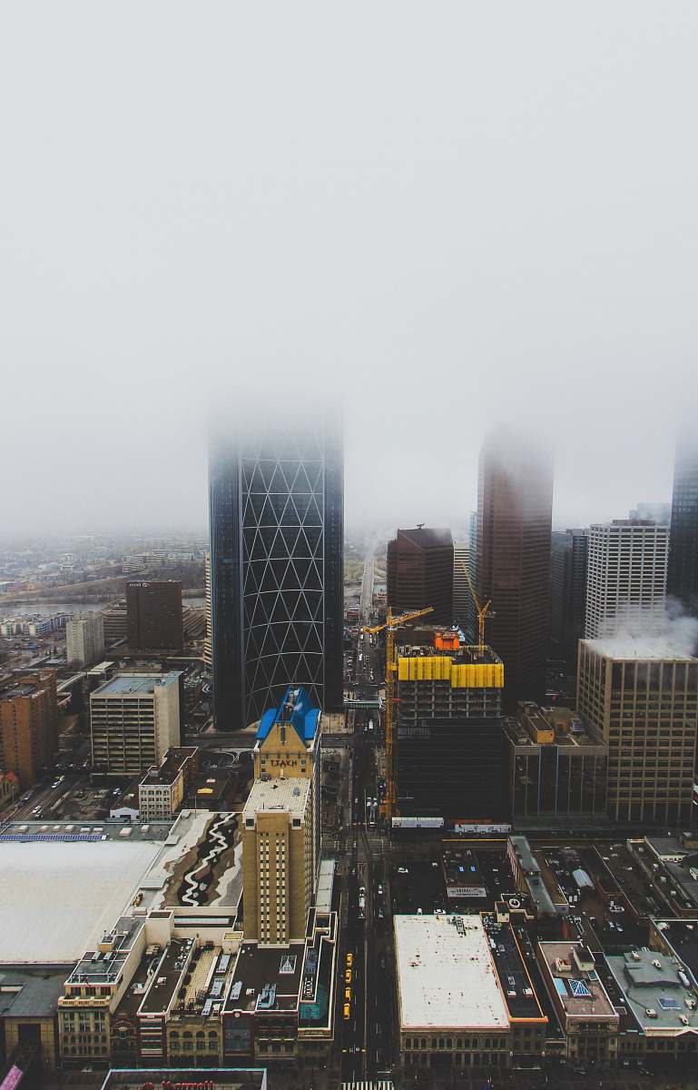 nature aerial photography of buildings under cloudy sky outdoors