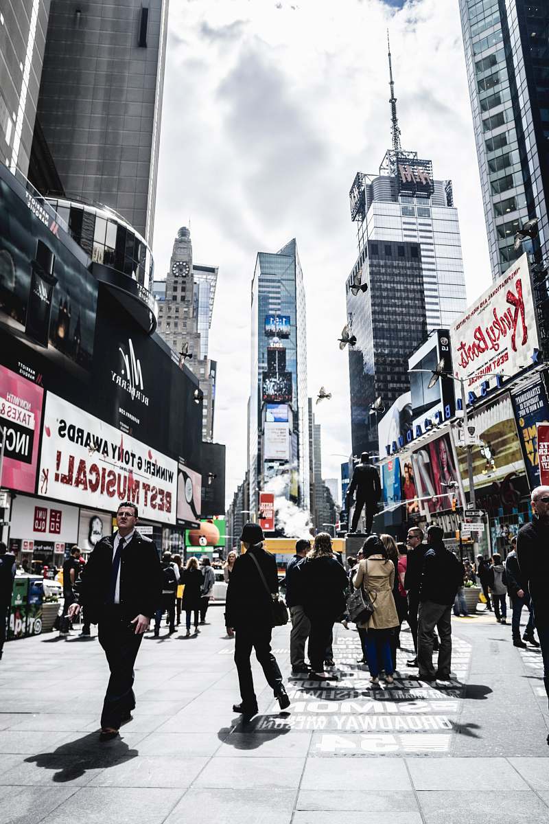 human people walking in street beside buildings person