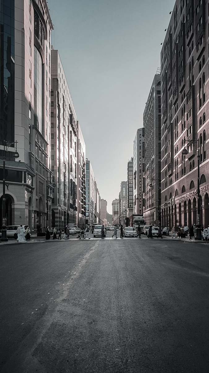 black-and-white people crossing road during daytime town
