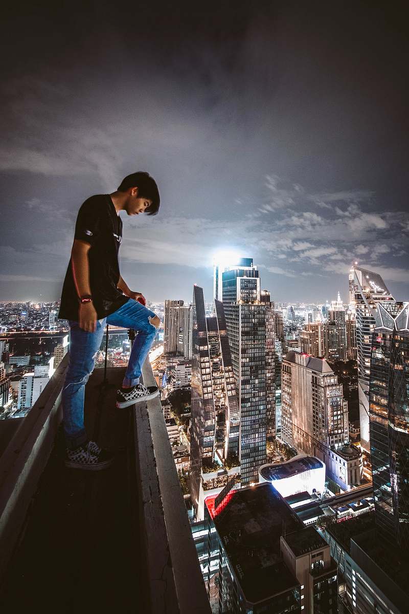 city man looks down from the building apparel