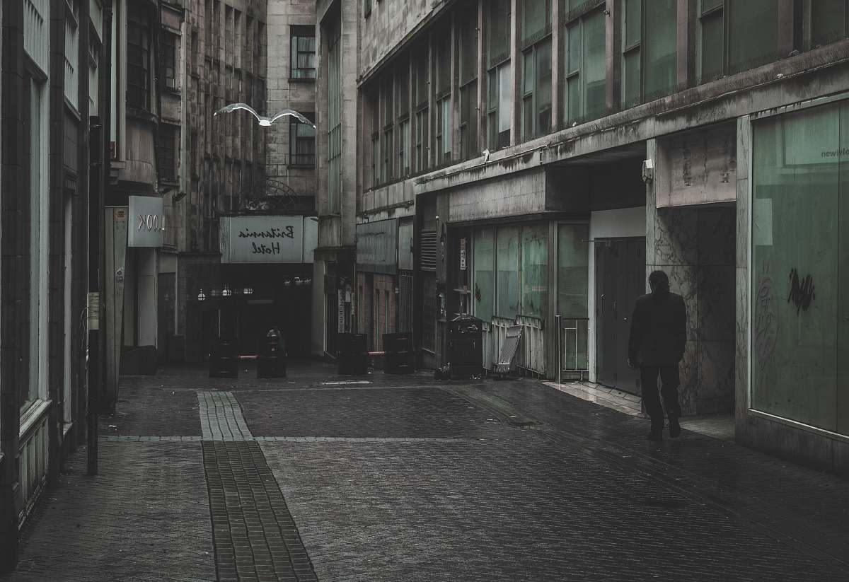 path man standing between building walkway