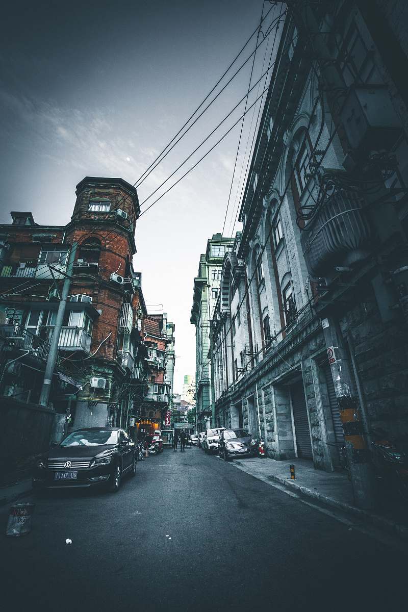 building black sedan parked on road street