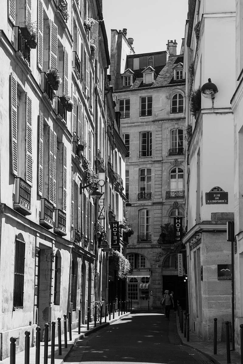 road grayscale photography of high buildings black-and-white