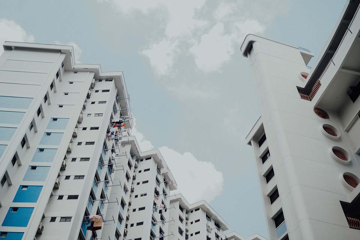 town low-angle photo of white building under white sky city
