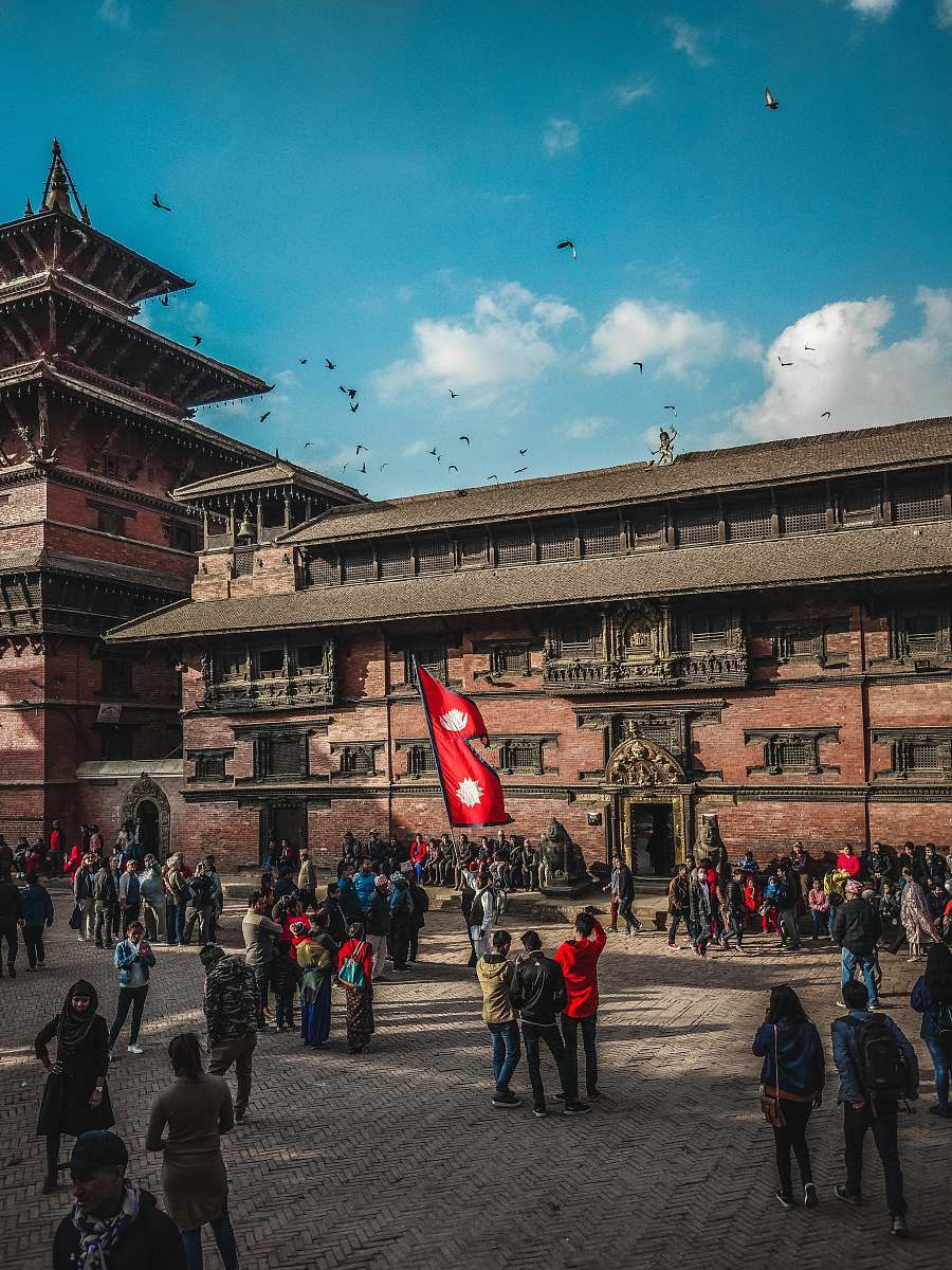 town people standing near building during daytime city