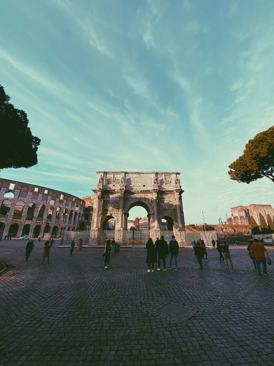 town people standing near The Colosseum building