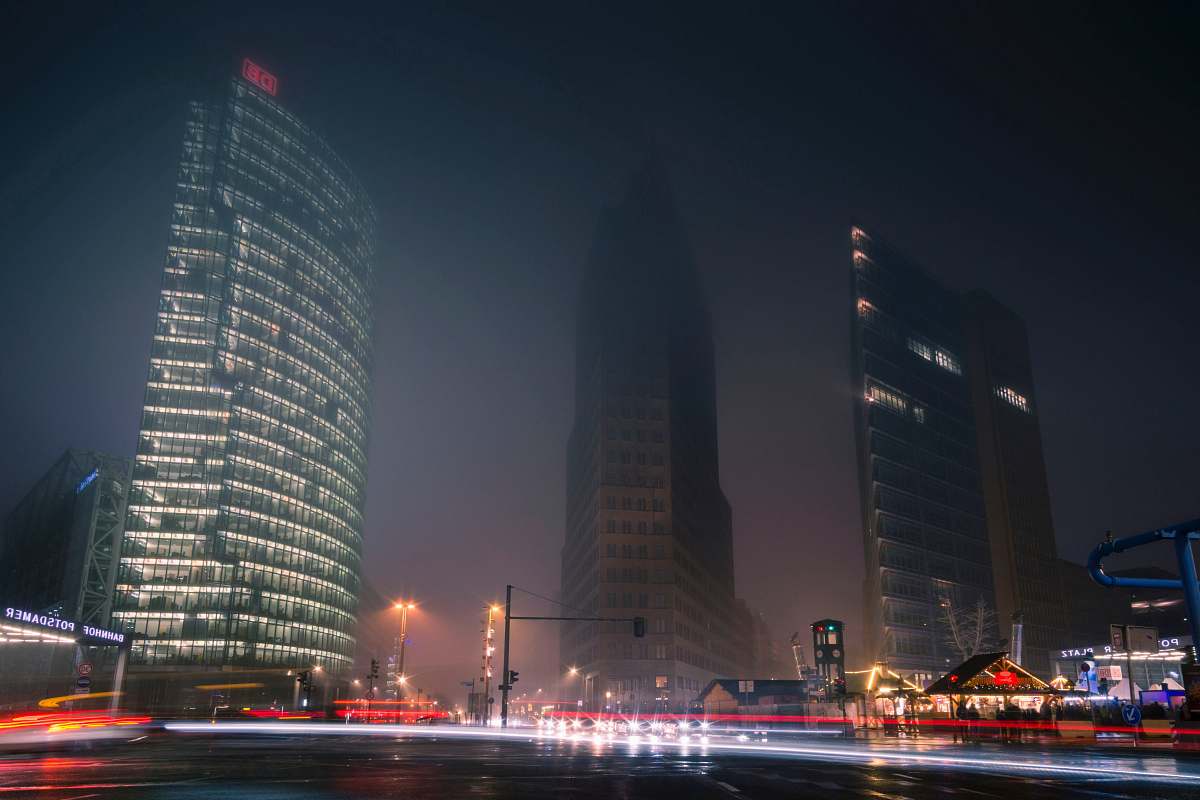 city three gray high-rise buildings at night time town