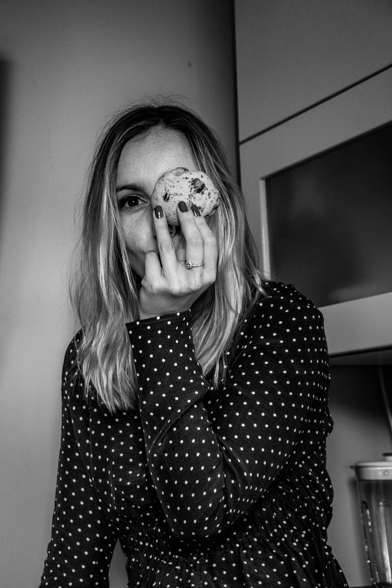 human woman near wall grayscale photo person