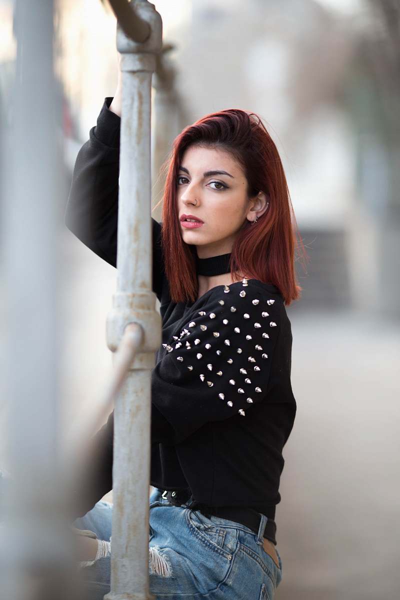 barcelona woman sitting on fence apparel