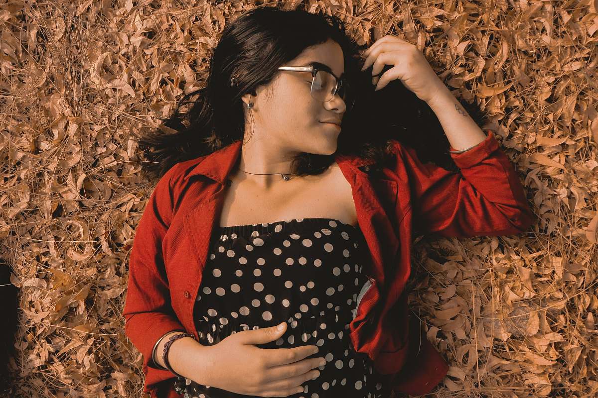 person woman lying on ground apparel