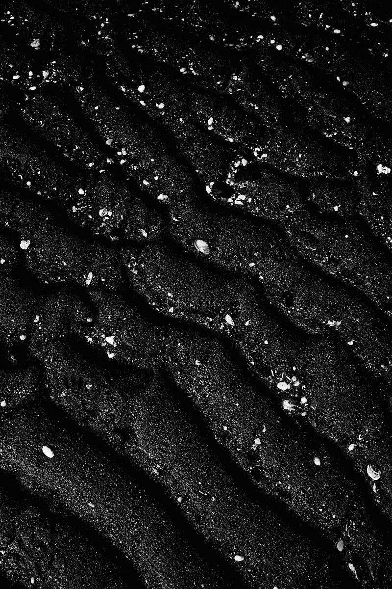 Immerse yourself in the tranquil beauty of this captivating black and white beach photography. The monochrome tones capture the raw essence of nature, showcasing gentle waves lapping at the shore, dramatic skies, and the serene ambiance of a secluded coastline. Perfect for use in travel brochures, art prints, or as a stunning backdrop for a minimalist design project, this image evokes a sense of peace and contemplation.