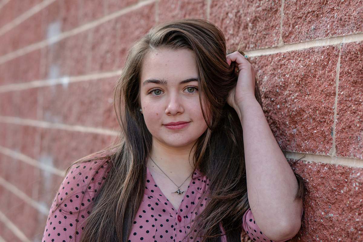 human woman in pink and black polka dot shirt brick