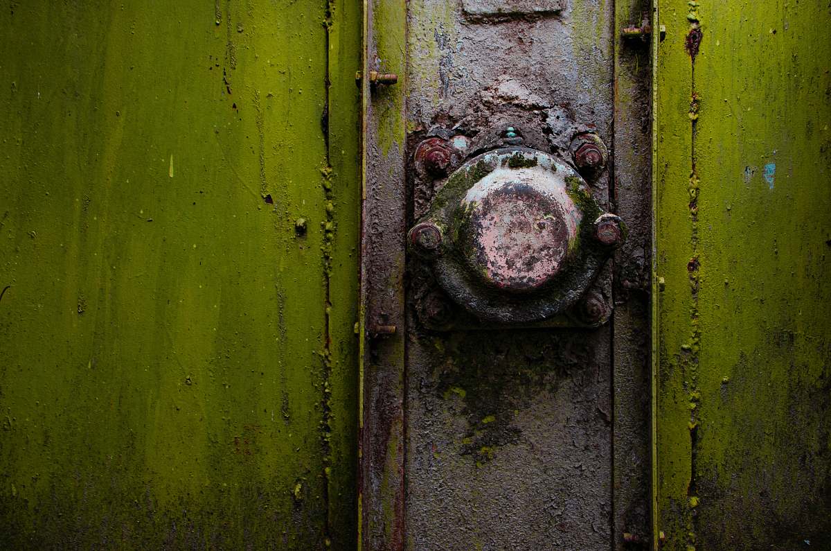 rust A close-up of a rusty metal knob on a green strongbox romania