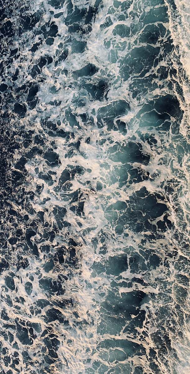 rug aerial view of sea waves during daytime rock