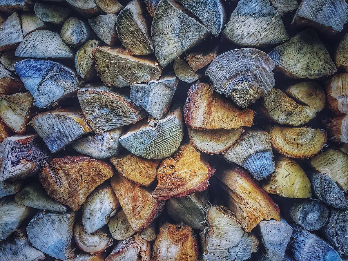 This captivating image showcases a diverse assortment of colorful firewood stacked neatly, creating a visually appealing background. Ideal for use in projects related to nature, woodworking, camping, or cozy home decor, this woodpile exudes warmth and character, making it a perfect choice for advertisements, brochures, or digital content that seeks to evoke a sense of rustic charm and outdoor adventure.