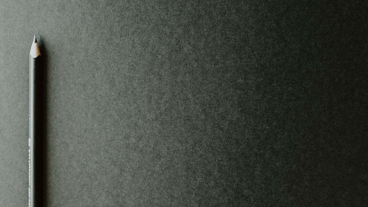 grey black pencil on black surface word