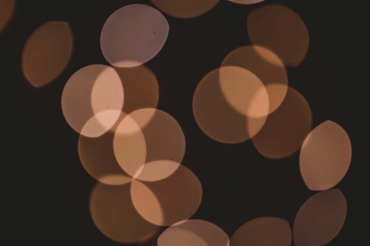 brown bokeh lights face