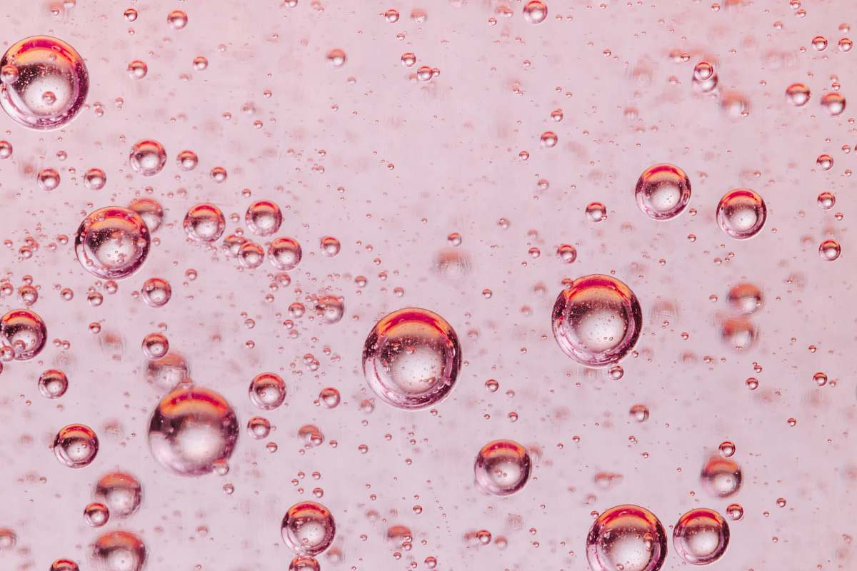 pink close-up photo of water drops droplet