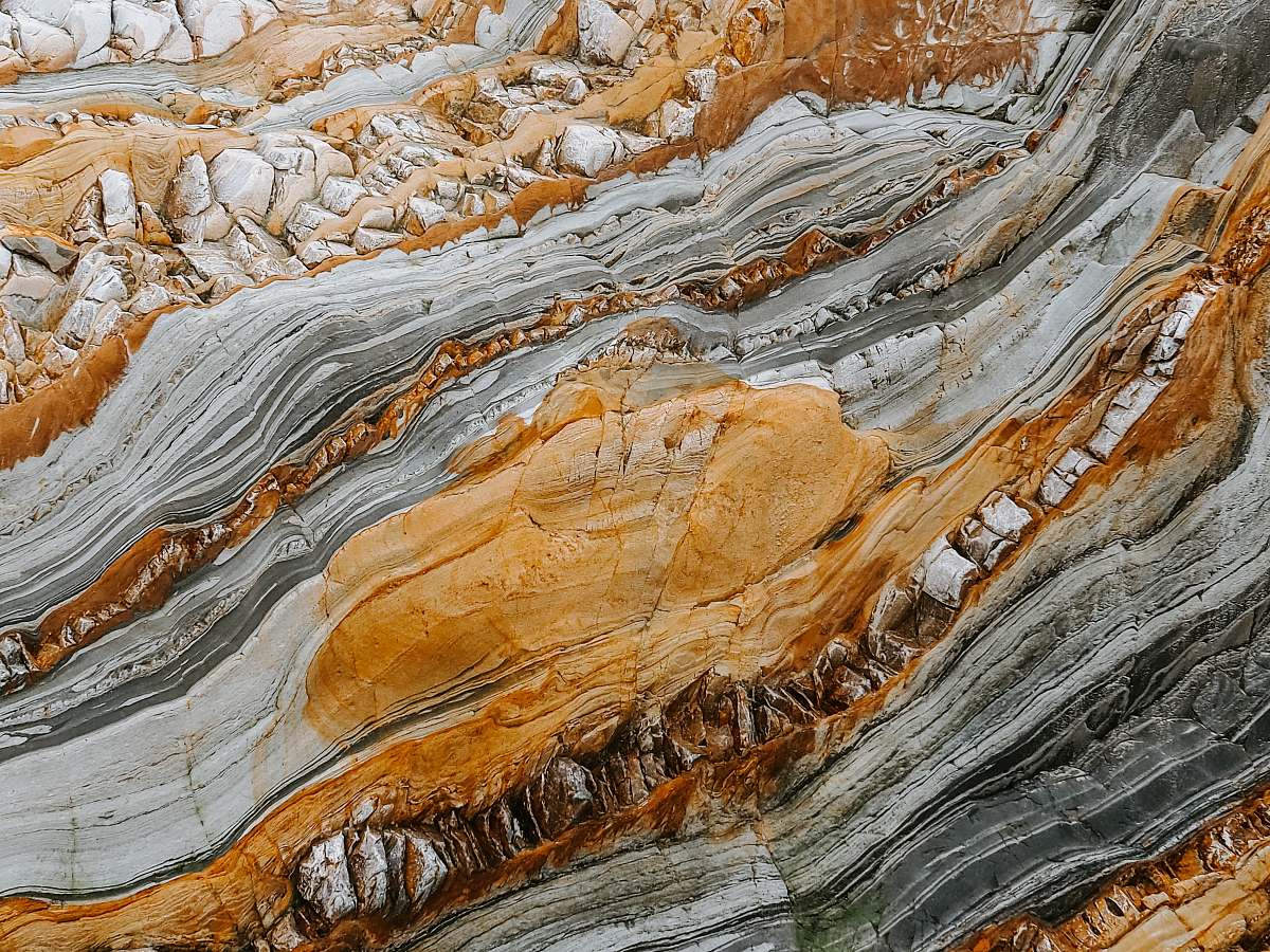 nature close-up photography of gray and orange stones playa del silencio