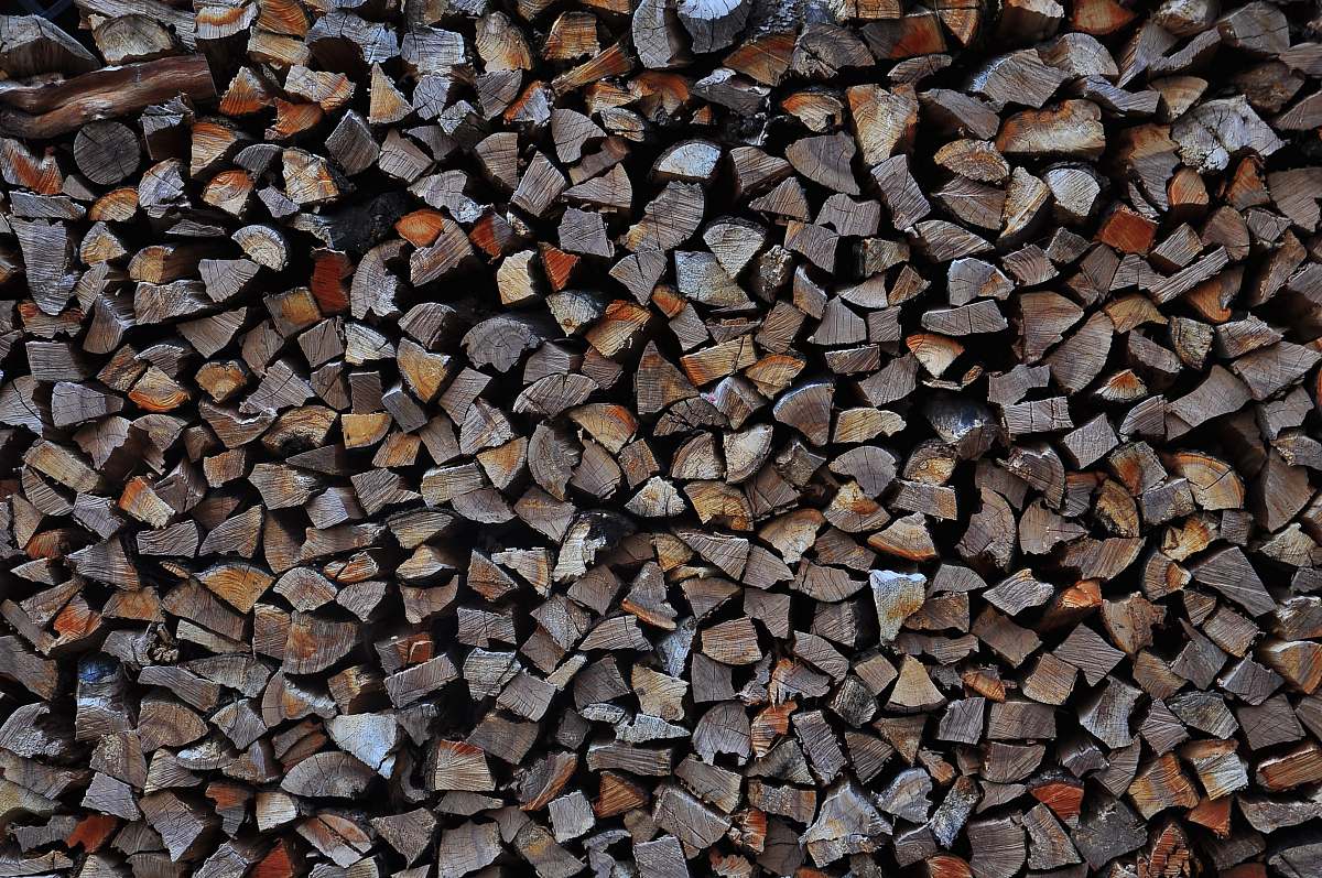 Discover a beautifully composed image of a pile of gray firewood, artfully nestled among smooth pebbles. This scene captures the essence of rustic charm, perfect for conveying warmth and comfort in various applications. Ideal for use in home decor blogs, outdoor living magazines, or any projects focusing on nature-inspired aesthetics. The contrast of the textured wood against the pebbles creates a visually appealing element that can enhance gardening, camping, or eco-friendly themes.
